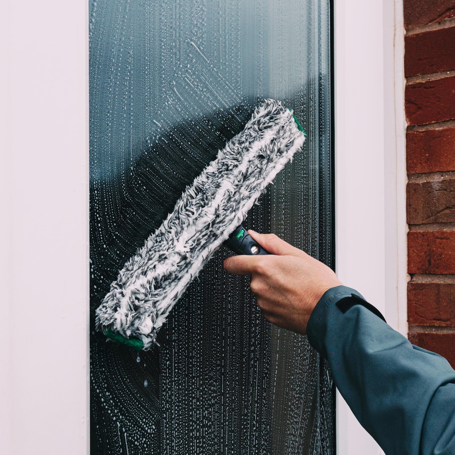 Professional traditional Window Cleaning T-bar being used by a window cleaner